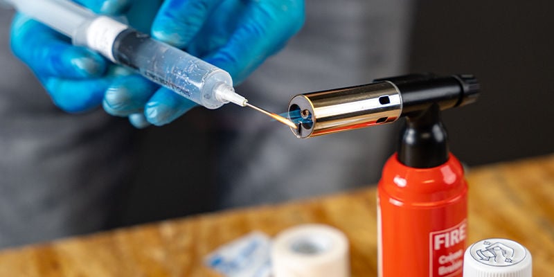 Sterilise the needle of your spore syringe with a flame