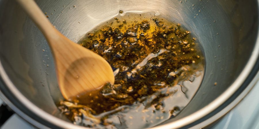 Set up a double boiler and heat the cannabis–coconut oil