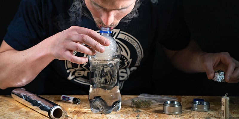 Gravity bucket bong: push the bong down into the water