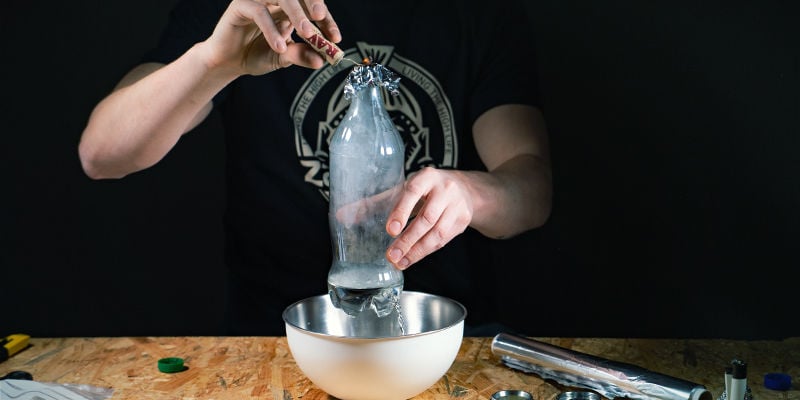 Waterfall gravity bong: Once the water has dropped beneath the hole, pull the aluminum foil off.