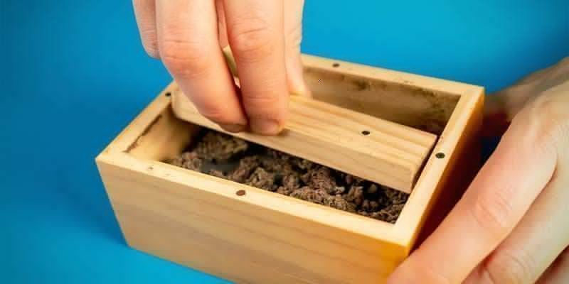 Open the sifter box and mix the now broken-down weed well