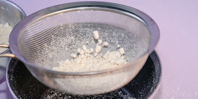 run the powder through a fine mesh sieve